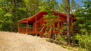 A wooden cabin with a porch, surrounded by trees. - Beavers Bend State Park entrance 259A , Southern Hill Addition; Wood Knot Cabin (Broken Bow)