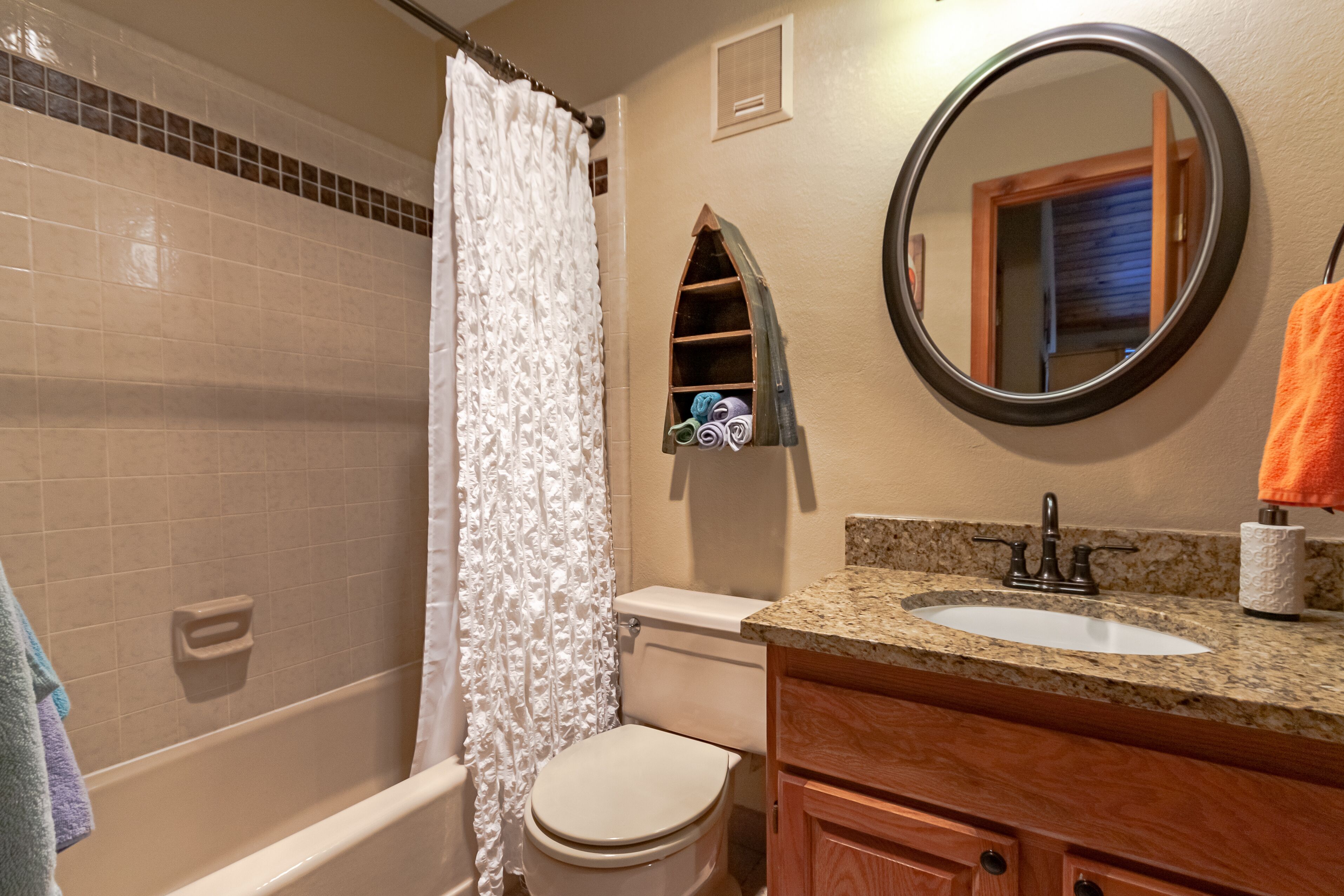 A bathroom with a bathtub, toilet, and sink.