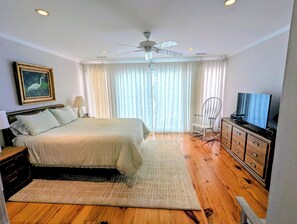 A bedroom with a bed, a television, a rocking chair, and a ceiling fan. - Overlooks Pool & Ocean.  3 BR, 3 BA, Isle of Palms, SC. Near Charleston,S.C. (Isle of Palms)