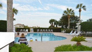 A swimming pool with lounge chairs, palm trees, and a building in the background. - Overlooks Pool & Ocean.  3 BR, 3 BA, Isle of Palms, SC. Near Charleston,S.C. (Isle of Palms)
