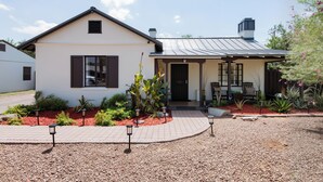 A two-story house with a front porch, a covered patio, and a landscaped garden. - Stay close to concerts, sports and culture in our artistic historic monarch home (Phoenix)
