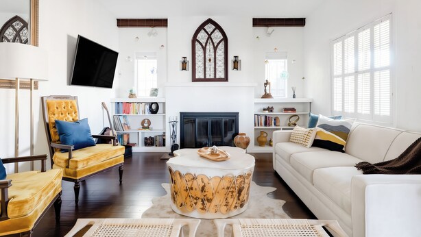 A living room with a fireplace, a round coffee table, a sofa, a chair, and a television. - Stay close to concerts, sports and culture in our artistic historic monarch home (Phoenix)