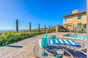 A poolside area with a clear view of the ocean, a pool, and a lounge chair with a striped towel. - UNOBSTRUCTED OCEAN-GOLF Views, step in shower, KING bed, garage, Gym
STR14-0115 (DANA POINT)
