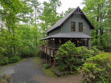 Summer Haven Cabin with parking area to side.