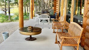 Relax in a cozy outdoor seating area surrounded by wooden beams and columns.