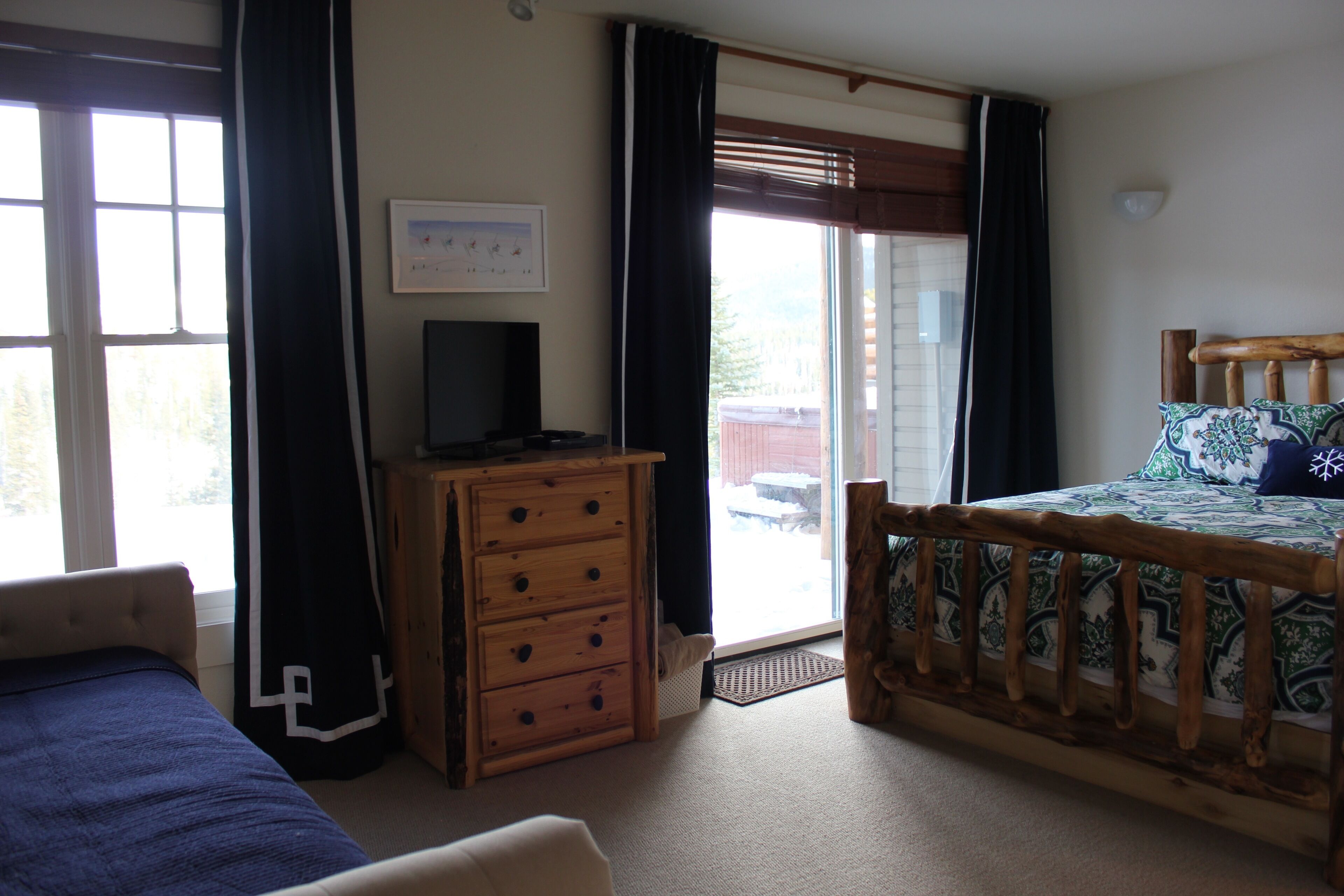 Master bedroom with slider out to patio and hot tub.
