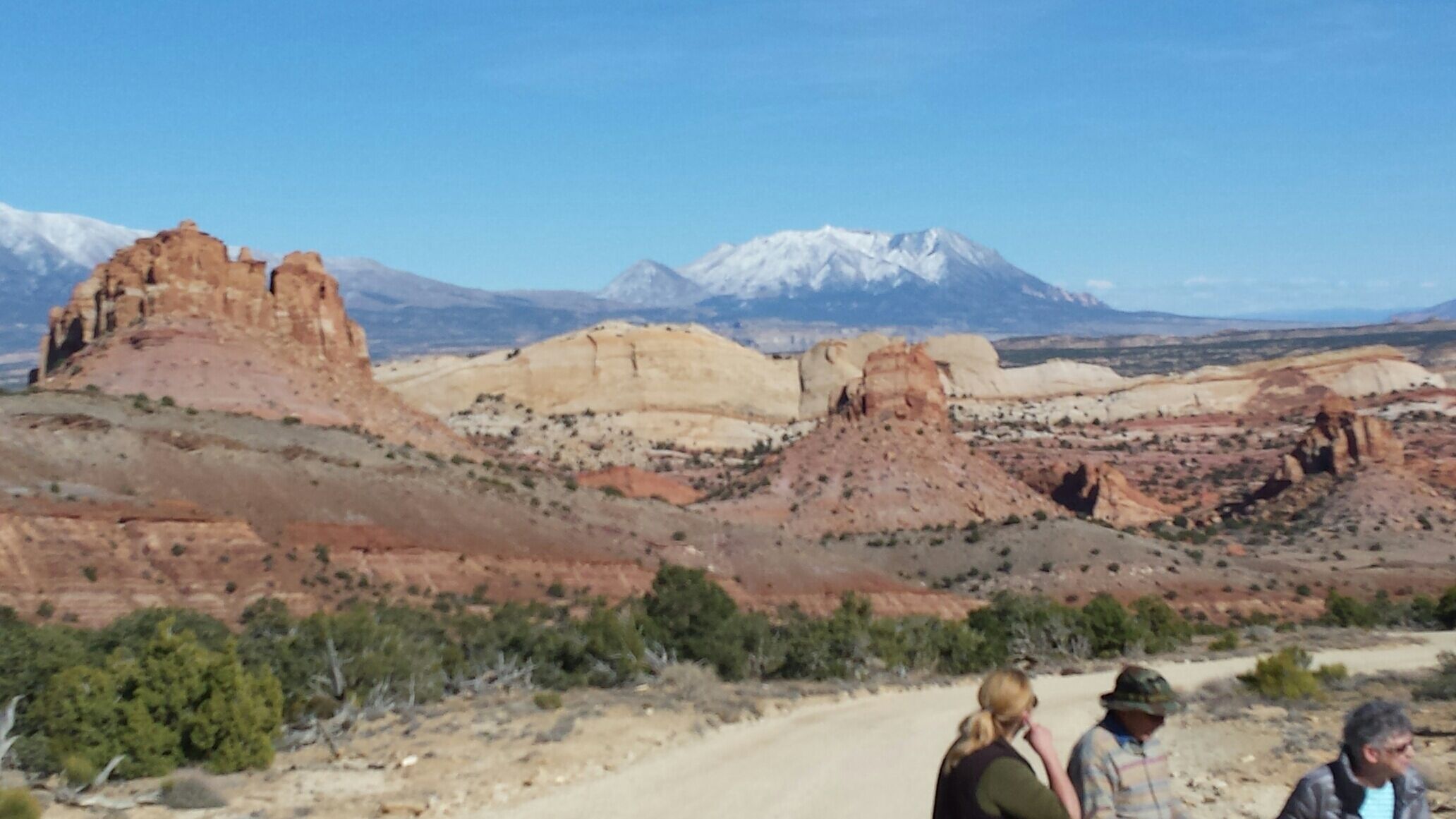 A desert landscape with rocky formations and a mountain in the background.