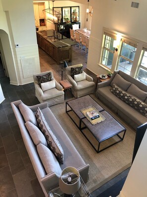 Relax in a spacious living area with a comfortable sectional sofa, armchair, and coffee table.