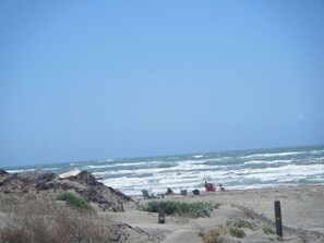 Enjoy a serene beach experience with comfortable beach chairs on the shore.