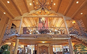 Experience the warm ambiance of Victory Lodge, featuring a grand staircase and elegant decor.