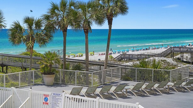 A beachside resort with a wooden deck, lounge chairs, and a view of the ocean. - JUST RENOVATED! Amazing Views!!! Beautiful Updated 2 Bedroom, 2 Bath condo! (Miramar Beach)
