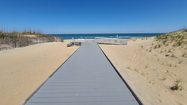 A beach pathway leading to a sandy beach with a clear blue sky. - "He Crab She Crab"  Waterfront Home w/Beach, Bay&Backyard Fun. Perfect for Kids! (Virginia Beach)