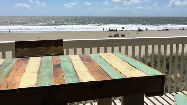 A wooden deck with a view of the beach and ocean. - Perfect in every Way: Nothing to do but relax (Kure Beach)