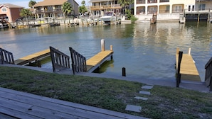 A marina with wooden docks and a boat docked. - Perfect ground floor unit ready to entertain your family vacation.  (Corpus Christi)