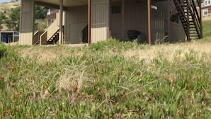 A two-story house with a balcony, a staircase, and a wooden deck. - Seaside Modern - Easy 3 min Walk to Beach! (Dillon Beach)