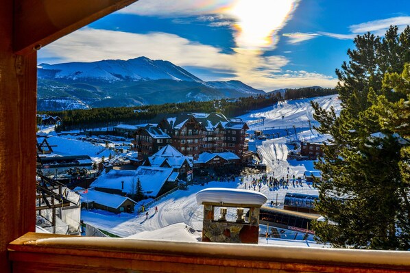 A snow-covered mountain town with a prominent lodge and ski slopes.