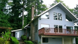 A two-story house with a garage, a balcony, and a small front yard.