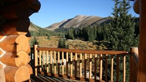 A wooden deck with a view of a mountainous landscape. - Exclusive 23-Acre Rocky Mtn. Retreat - Featured in a Music Video!  Unforgettable (Fairplay)