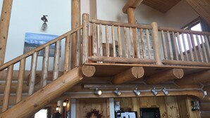 A wooden staircase with a railing leading to a second-floor balcony. - Exclusive 23-Acre Rocky Mtn. Retreat - Featured in a Music Video!  Unforgettable (Fairplay)