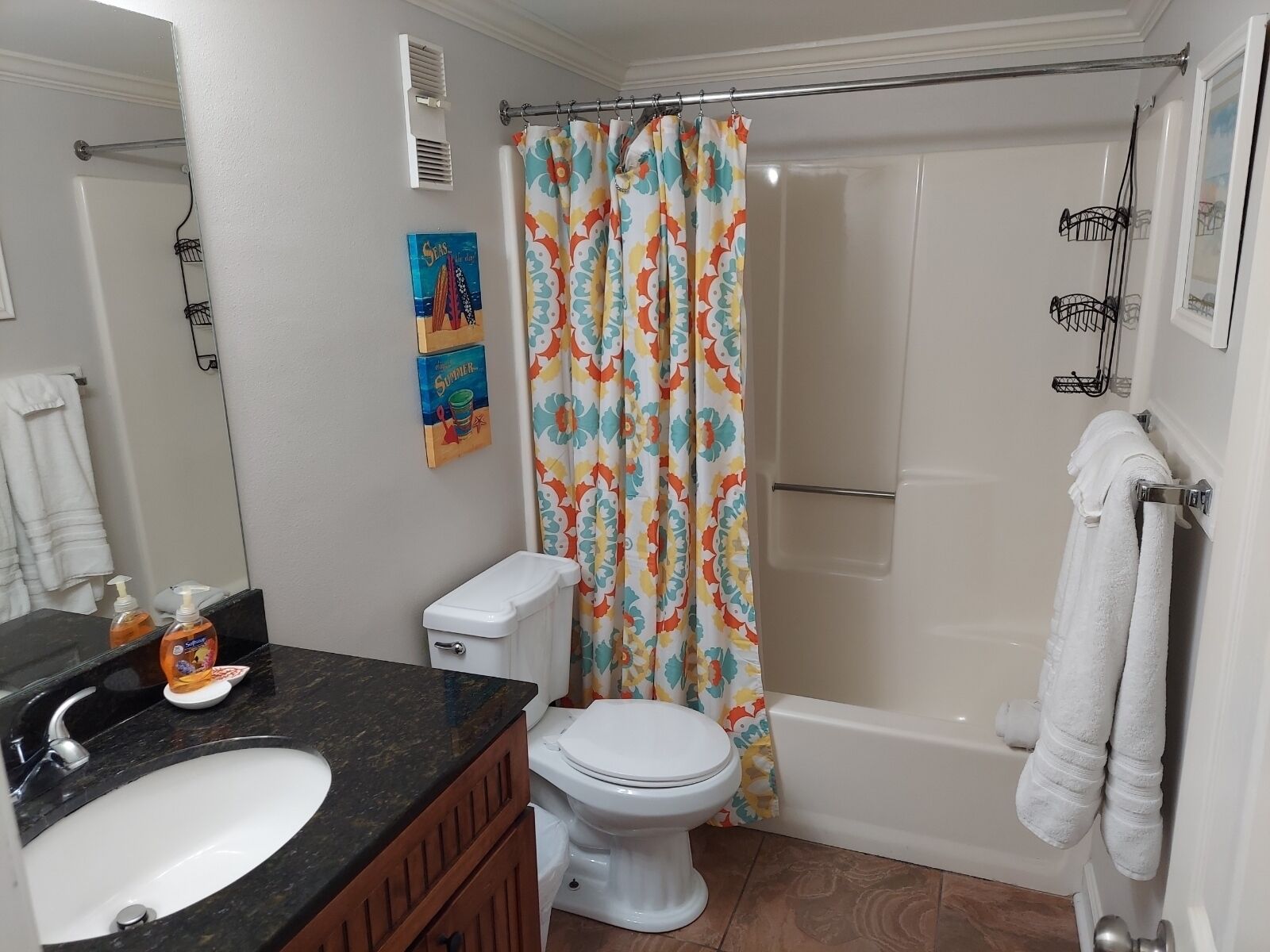 A bathroom with a toilet, sink, and bathtub.