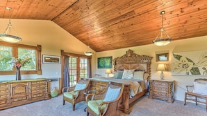 A spacious bedroom with a large bed, wooden ceiling, and a dresser. - Carmel Valley Village, close to Big Sur, Pebble, Carmel, & Monterey (Carmel Valley)