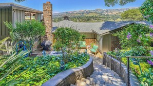 A residential property with a stone chimney, a stone staircase, and a view of rolling hills. - Carmel Valley Village, close to Big Sur, Pebble, Carmel, & Monterey (Carmel Valley)