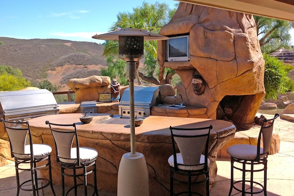 Outdoor kitchen and barbecue area with heat lamps for cool nights.