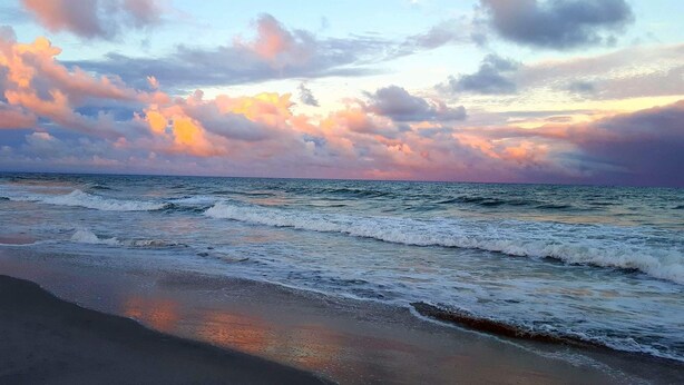 A beach with waves and a sunset sky. - Gorgeous 5 bdrm OCEAN LAKES FAMILY CAMPGROUND MH137C (Myrtle Beach)