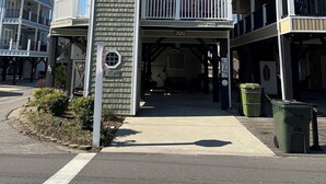 A multi-story building with balconies, a central entrance, and a small garden area. - Gorgeous 5 bdrm OCEAN LAKES FAMILY CAMPGROUND MH137C (Myrtle Beach)