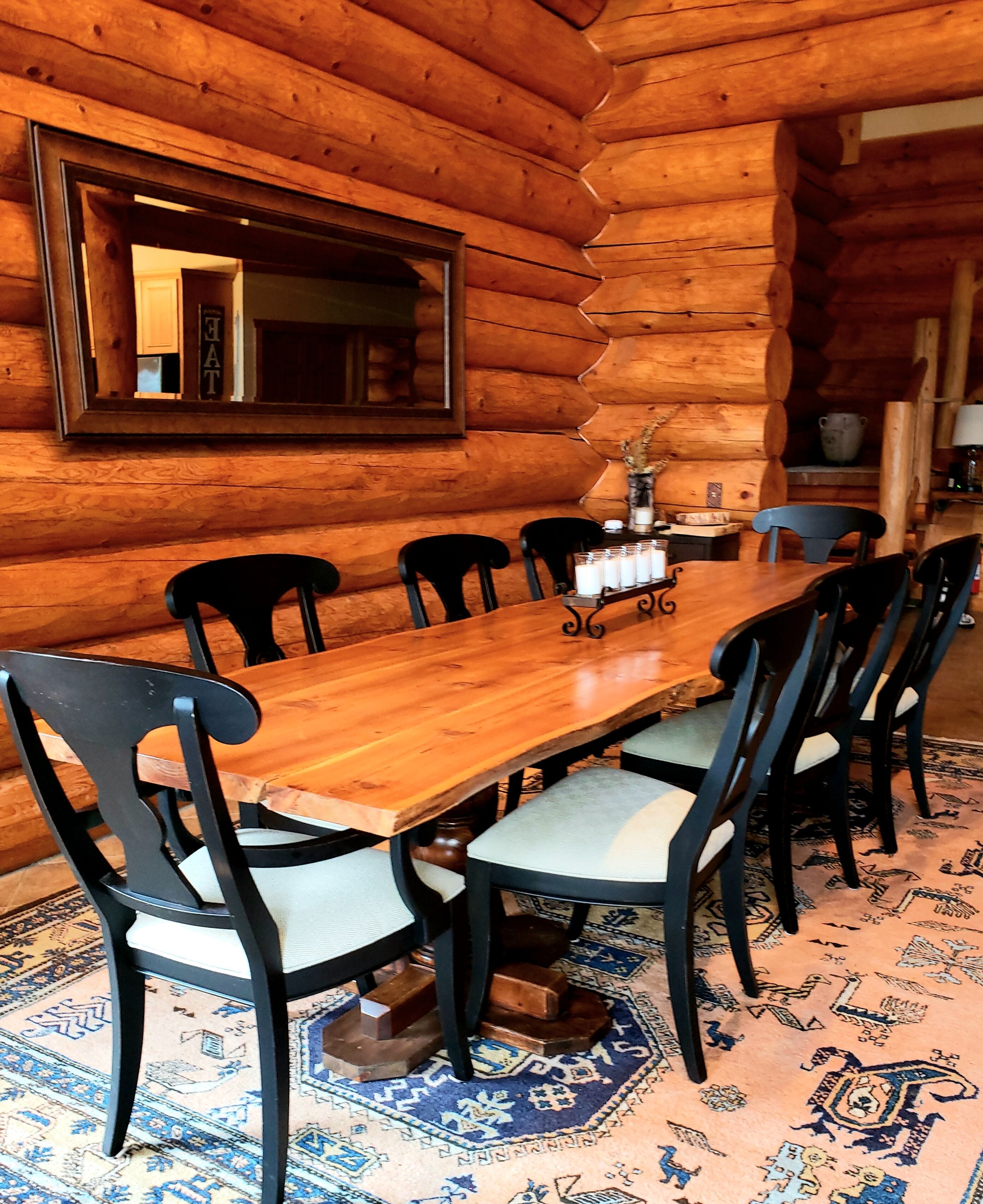 Live edge table seating for 8 and steps to the kitchen, faces the fireplace