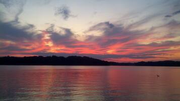 A calm lake with a sunset sky.