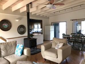 Relax in this spacious living area with a modern kitchen, dining space, and comfortable seating area.