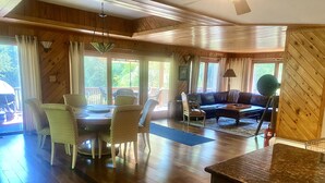 A spacious living area with a dining table, chairs, a sofa, and a coffee table. - Beautiful Saugerties Rental -Pool, Fire Pit, close to HITS, Hiking, Festivals (Saugerties)