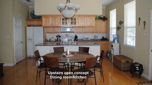 An open concept dining room/kitchen with wooden cabinets, a central island, and a chandelier. - Casa Del Sol I - Large Single-Family Home With Private Pool  (South Padre Island)