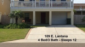 A two-story house with a balcony, labeled "109 E. Lantana." It has 4 bedrooms and 3 bathrooms, with 12 sleeping areas. - Casa Del Sol I - Large Single-Family Home With Private Pool  (South Padre Island)