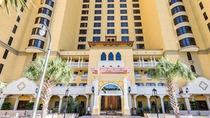 A multi-story hotel with a central entrance, balconies, and palm trees. - Spectacular VIP Corner Oceanfront @ Anderson Ocean, Wrap-Around Balcony 2B/2Ba (Myrtle Beach)