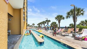 A swimming pool area with lounge chairs and palm trees. - Spectacular VIP Corner Oceanfront @ Anderson Ocean, Wrap-Around Balcony 2B/2Ba (Myrtle Beach)