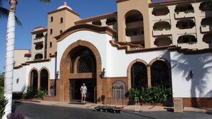 A hotel with a white facade, multiple balconies, and a central arched entrance. - Ground Floor, Oceanview And Oceanfront  (San Jose del Cabo)