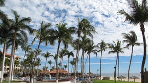 A resort with palm trees, a pool area, and beach umbrellas. - Ground Floor, Oceanview And Oceanfront  (San Jose del Cabo)