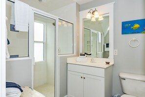A bathroom with a white vanity, a mirror, and a toilet. - 3BR/3.5 BA home with private crofter. Nature views and access to Shoals Club! (Bald Head Island)