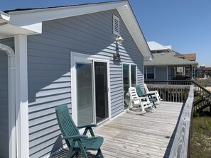 A house with a covered porch, two green chairs, and a white fence. - Rideout's Hideout - Easy Beach Access - Sound Views - Family & Pet Friendly (Topsail Beach)