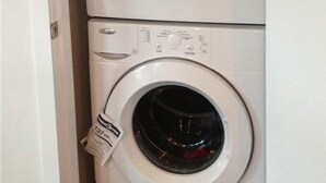 A stacked washer and dryer unit with a visible tag on the dryer. - 2 Bedroom Apt RIVER & MOUNTAIN VIEWS , IN THE HEART OF WHITEHORSE - condo (Whitehorse)