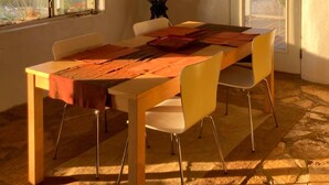 A dining area with a table, chairs, and a view of the outdoors. - Big Bend Getaway: Classic Adobe with Modern Flair (Terlingua)