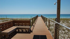 A wooden boardwalk leading to a beach with a bench and a wooden structure with a light fixture. - Spacious Belle Mer 3BR -- 2 Gulf Front Masters -- All with Private Baths (Navarre Beach)