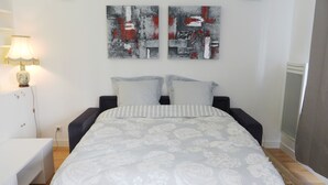 A bedroom with a bed, two pillows, a bedside table, a lamp, and abstract wall art. - ETOILE, LIVELY, FRESH MARKET, 30–60 days ahead? Ask for a private offer. PON-VAp (Paris)