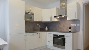 A modern kitchen with white cabinets, stainless steel appliances, and a grey countertop. - ETOILE, LIVELY, FRESH MARKET, 30–60 days ahead? Ask for a private offer. PON-VAp (Paris)