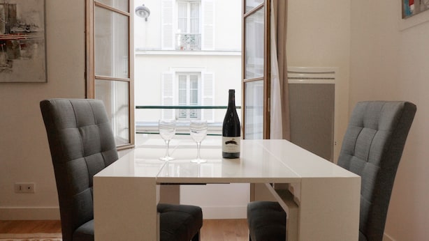 A dining table with four chairs, a bottle of wine, and two glasses. - ETOILE, LIVELY, FRESH MARKET, 30–60 days ahead? Ask for a private offer. PON-VAp (Paris)