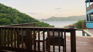 A wooden deck with a view of a mountainous landscape and a body of water. - Gorgeous View, Beach Access, Swimming Pool, Kayak, Quiet Privacy - the East End (St. John)