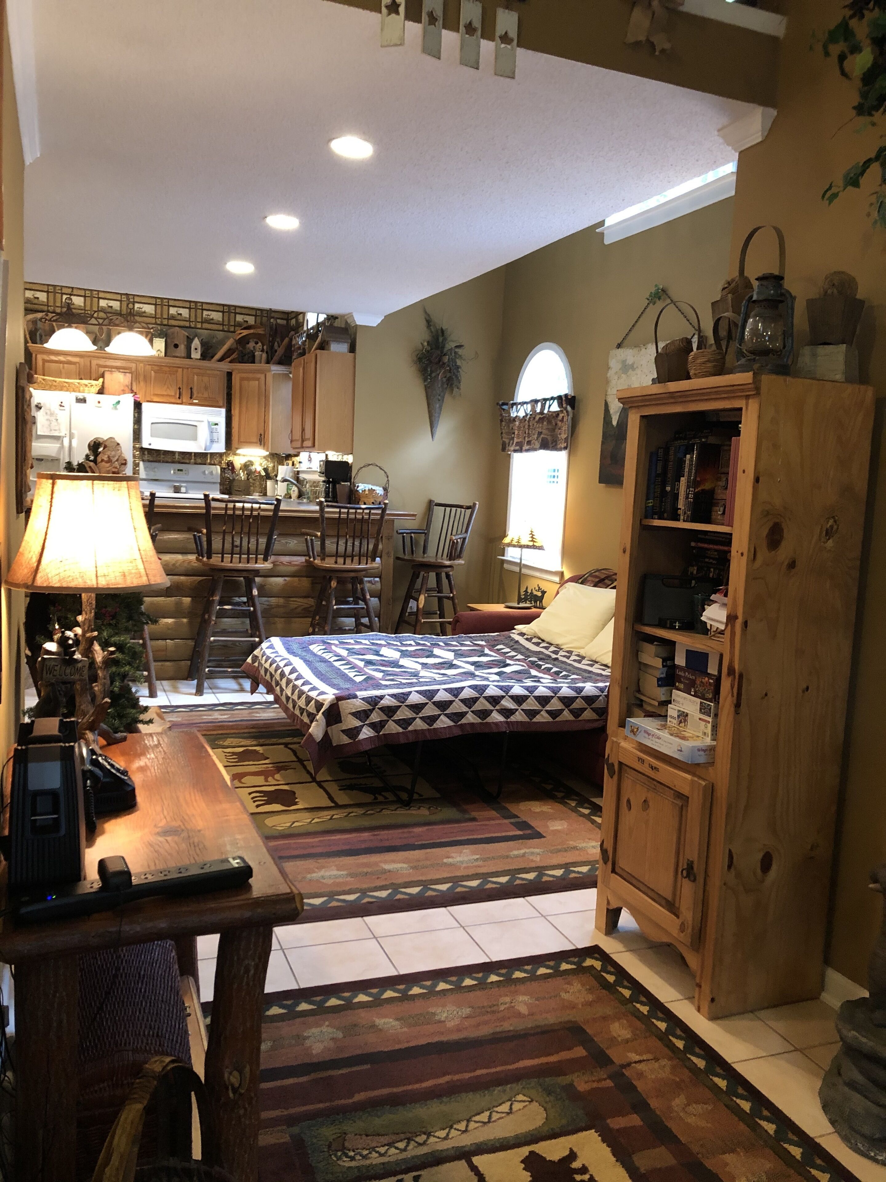 A cozy, compact living space with a kitchen, dining area, and a bed.