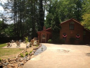 Cozy cabin with a welcoming entrance, perfect for relaxation and outdoor activities.